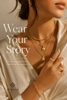 Elegant woman wearing layered gold jewellery in warm luxury lighting with a soft beige background, showcasing timeless necklaces, rings, and bracelets in a premium editorial fashion style with the text “Wear Your Story” for Jubris Jewelry.